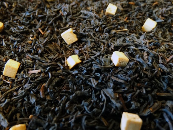 Black tea, pieces of caramel.