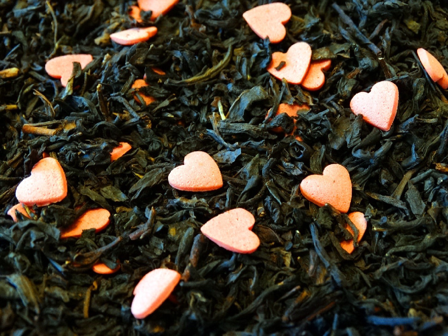 Black tea, peach, dried fruits, decoration small hearts